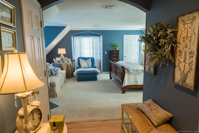 bedroom with hardwood / wood-style floors and ornamental molding