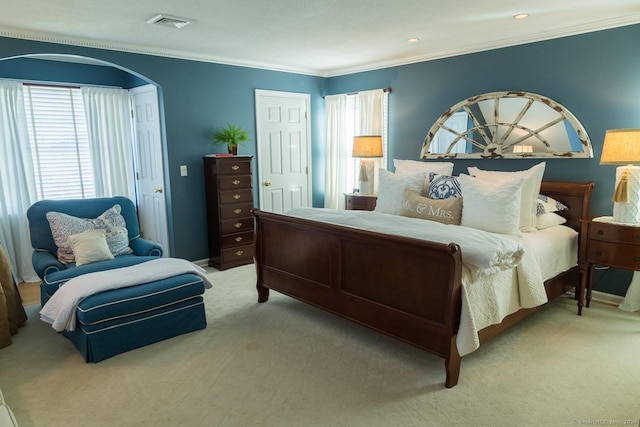 carpeted bedroom with ornamental molding