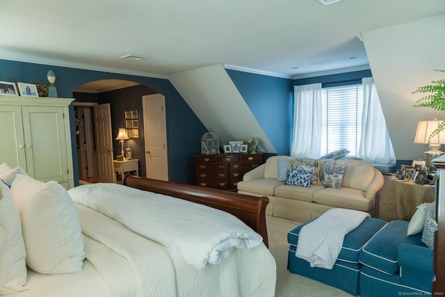 carpeted bedroom with crown molding and vaulted ceiling