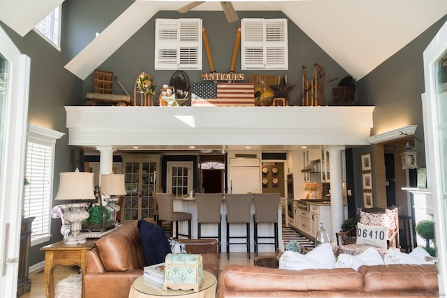 living room with high vaulted ceiling