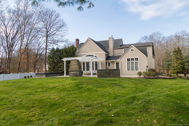 rear view of house with a pergola and a lawn