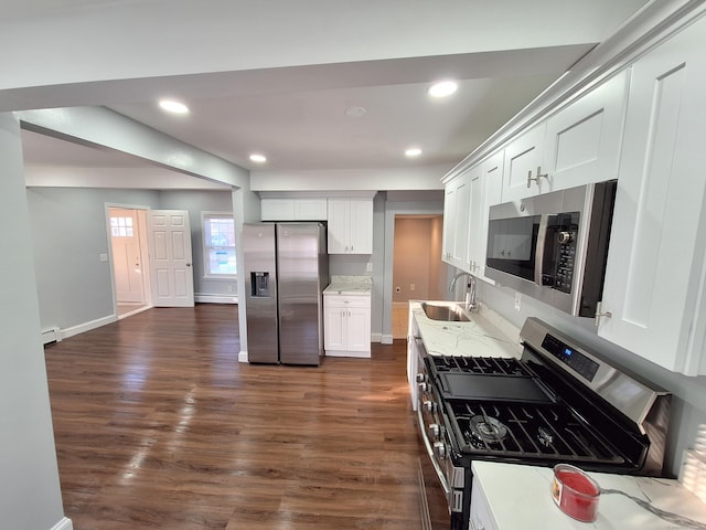 kitchen featuring dark wood-type flooring, sink, light stone counters, white cabinetry, and stainless steel appliances