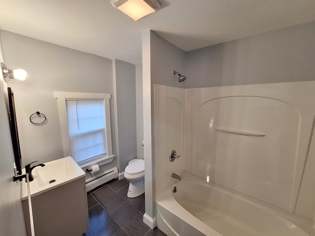 full bathroom featuring washtub / shower combination, toilet, vanity, and a baseboard heating unit