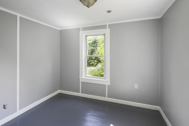 unfurnished room featuring dark hardwood / wood-style floors and crown molding