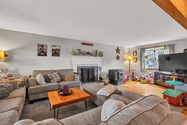 living room with hardwood / wood-style floors and a wood stove