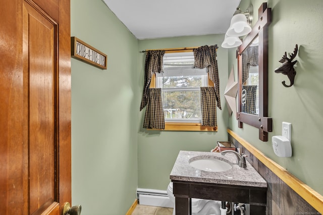 bathroom featuring tile patterned flooring, vanity, and a baseboard radiator