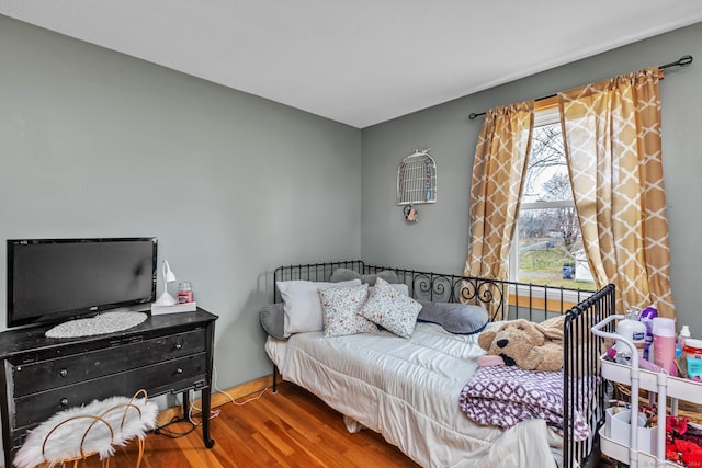 bedroom featuring hardwood / wood-style floors and multiple windows