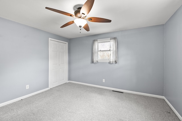 carpeted empty room with ceiling fan