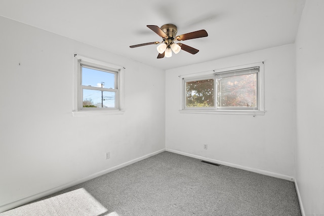 carpeted empty room featuring ceiling fan