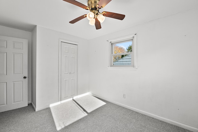 unfurnished bedroom featuring carpet, a closet, and ceiling fan