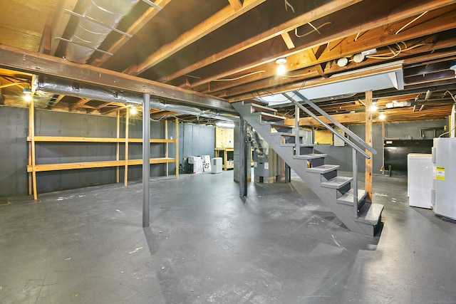 basement featuring heating unit, washer and dryer, and water heater