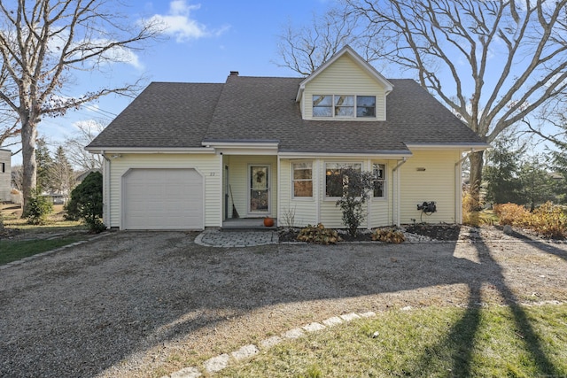 cape cod house featuring a garage