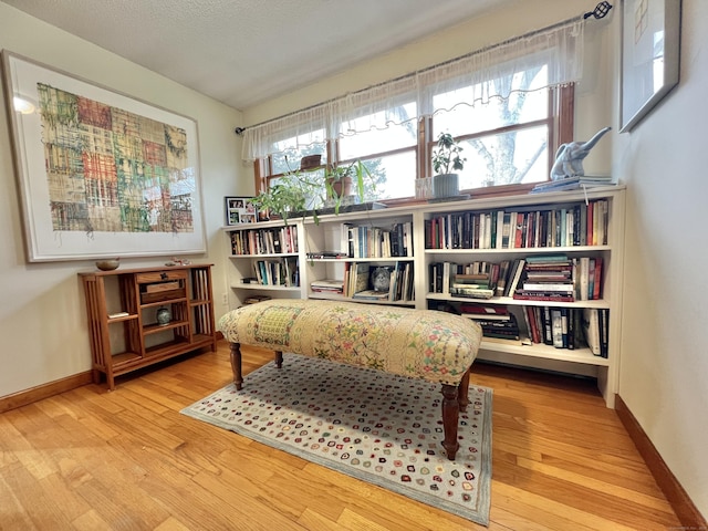 sitting room featuring a textured ceiling and hardwood / wood-style flooring