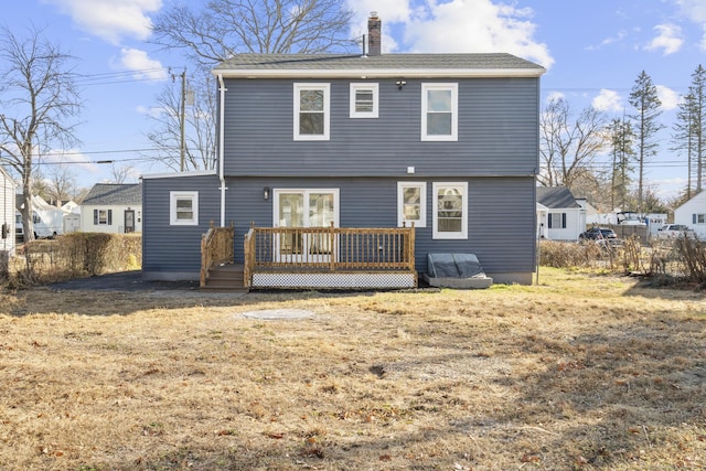 rear view of house with a yard and a deck