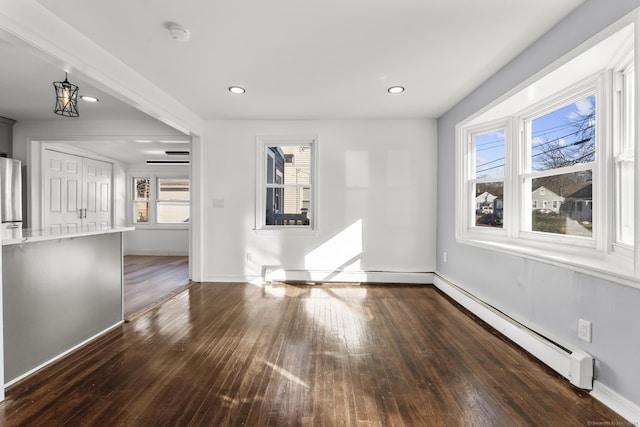 interior space featuring a chandelier, dark hardwood / wood-style flooring, and baseboard heating