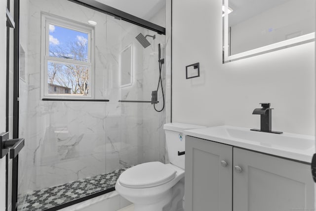 bathroom with vanity, toilet, and walk in shower