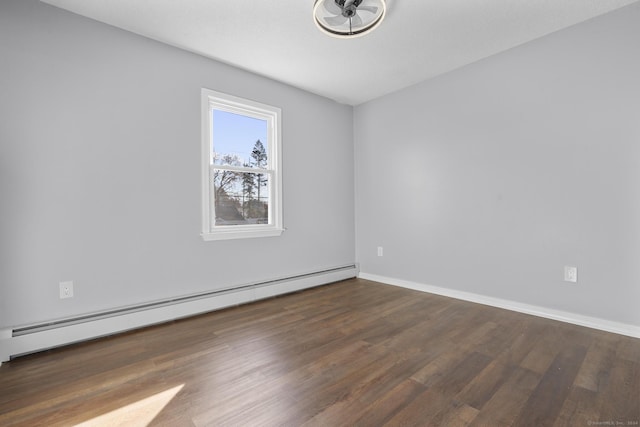 unfurnished room with dark hardwood / wood-style floors and a baseboard heating unit