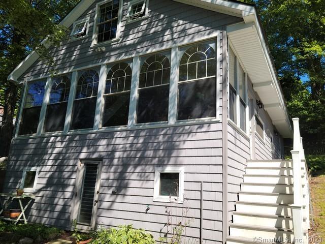 view of side of home featuring a sunroom