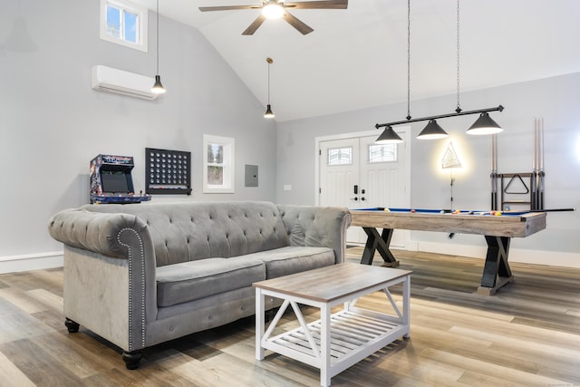 living room featuring hardwood / wood-style floors, electric panel, high vaulted ceiling, an AC wall unit, and ceiling fan