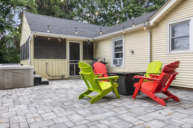 view of patio with a hot tub, central AC unit, and a sunroom