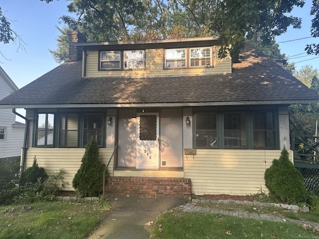 146 Johnson St, Naugatuck, CT 06770 - view of front of house with roof with shingles, a chimney, a sunroom, and entry steps