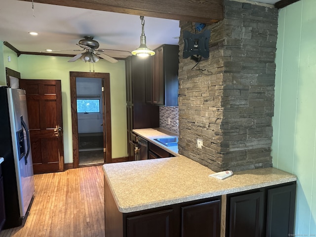 kitchen with backsplash, stainless steel refrigerator with ice dispenser, hanging light fixtures, ceiling fan, and light wood-type flooring