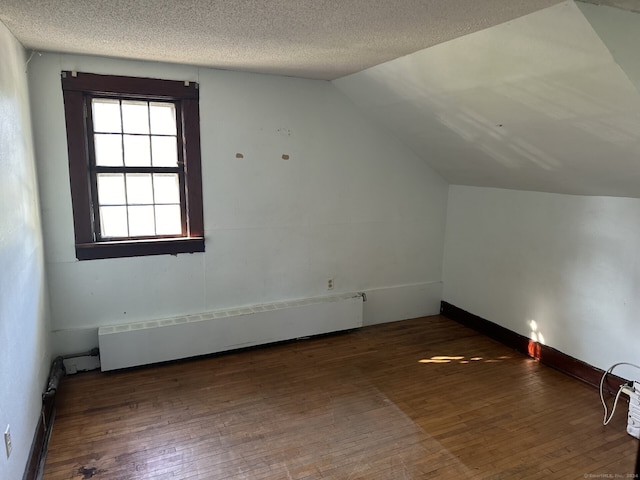 146 Johnson St, Naugatuck, CT 06770 - bonus room with hardwood / wood-style flooring, baseboard heating, vaulted ceiling, and a textured ceiling