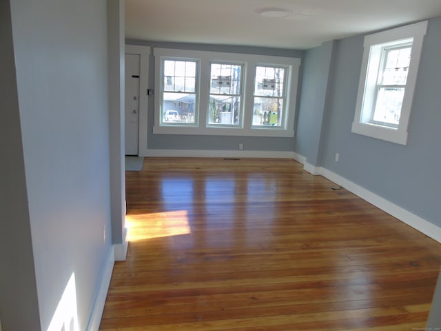 unfurnished room featuring baseboards and wood finished floors