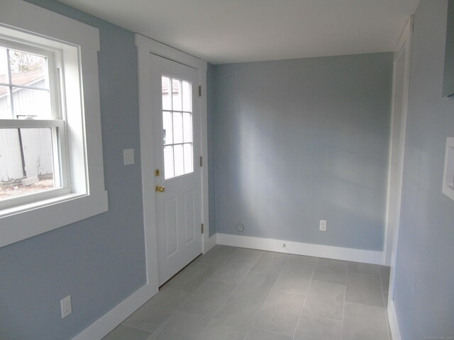 entryway featuring plenty of natural light and baseboards