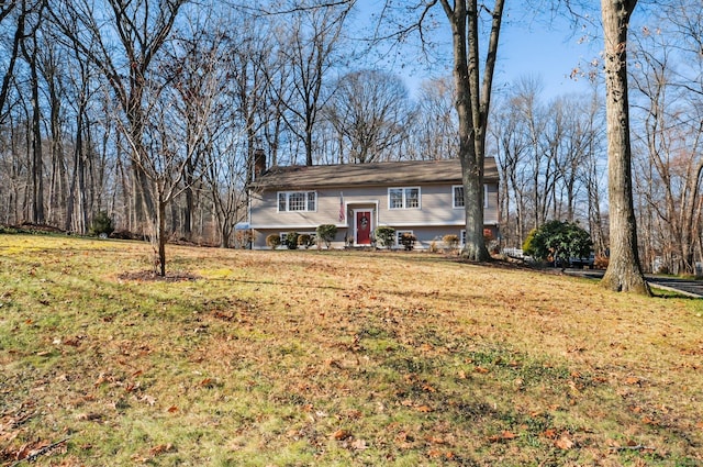 raised ranch featuring a front lawn