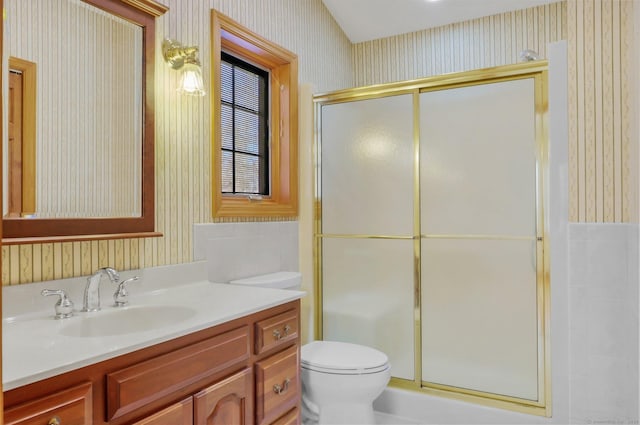 bathroom with vanity, a shower with shower door, and toilet