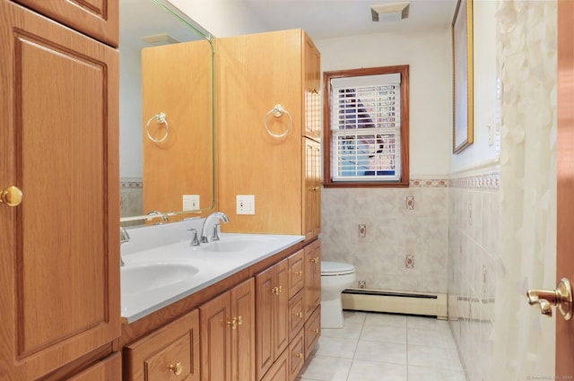 bathroom featuring vanity, tile patterned floors, toilet, tile walls, and a baseboard radiator