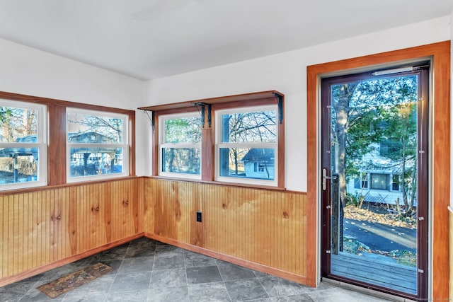 doorway featuring wooden walls