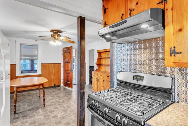 kitchen featuring black gas stove, white fridge, and ceiling fan