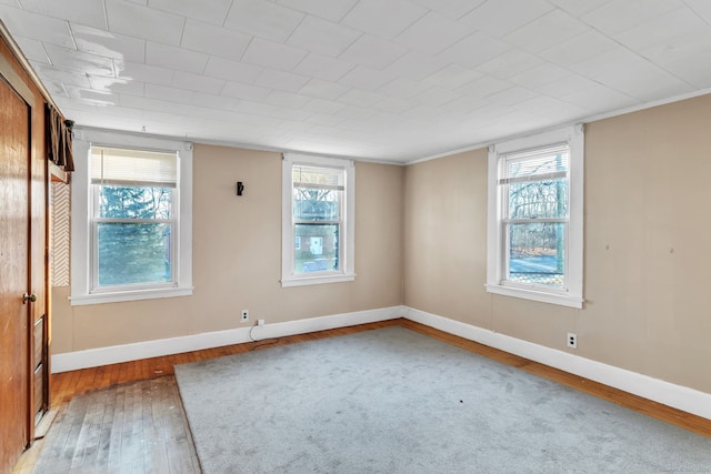 unfurnished room featuring a healthy amount of sunlight and hardwood / wood-style flooring