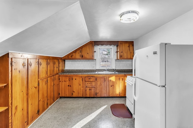 kitchen featuring backsplash, sink, and white appliances