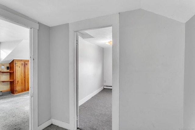 hallway with baseboard heating and vaulted ceiling