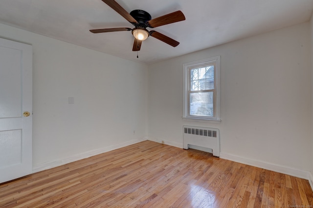 unfurnished room featuring light hardwood / wood-style floors, radiator, and ceiling fan