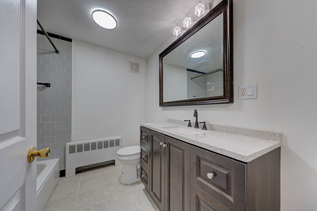 full bathroom with radiator heating unit, tile patterned floors, toilet, vanity, and tiled shower / bath