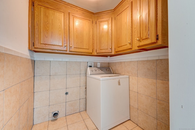 washroom featuring cabinets, light tile patterned floors, washer / clothes dryer, and tile walls