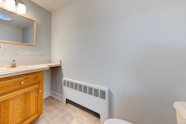 bathroom featuring tile patterned floors, radiator heating unit, vanity, and toilet