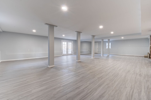 basement with french doors and light wood-type flooring