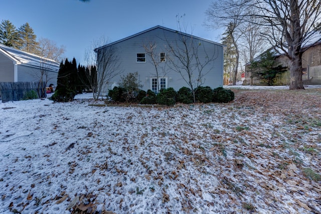 view of snow covered rear of property