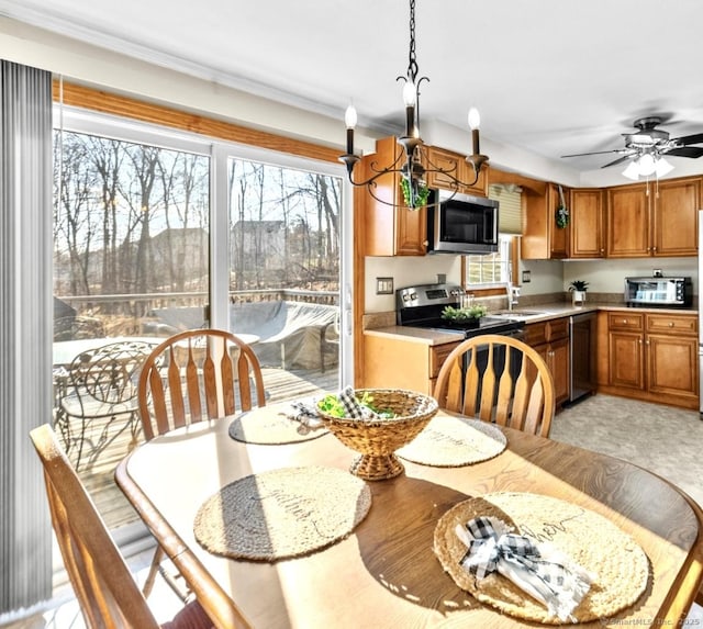 dining area featuring crown molding, a wealth of natural light, and ceiling fan