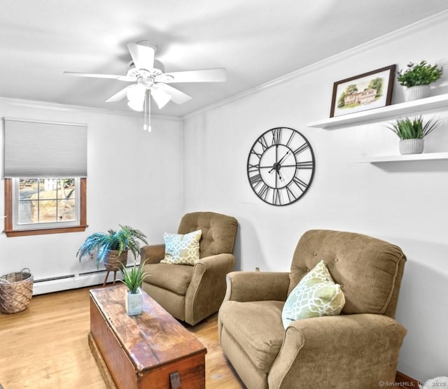 living area with crown molding, ceiling fan, baseboard heating, and light hardwood / wood-style floors