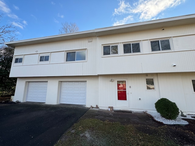 multi unit property featuring a garage