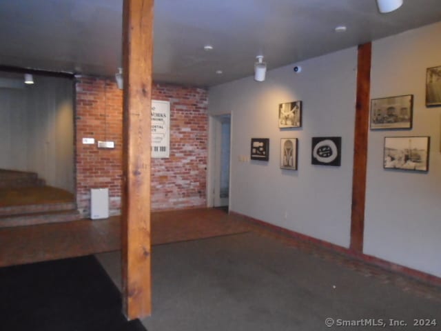 basement featuring brick wall