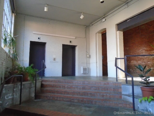 entrance to property with a porch and elevator