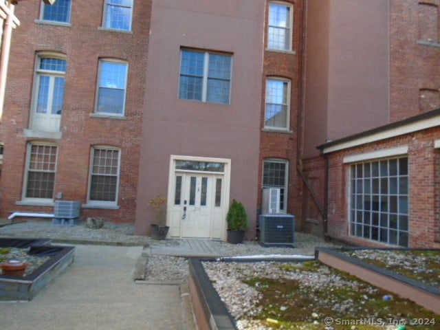 back of property featuring central air condition unit