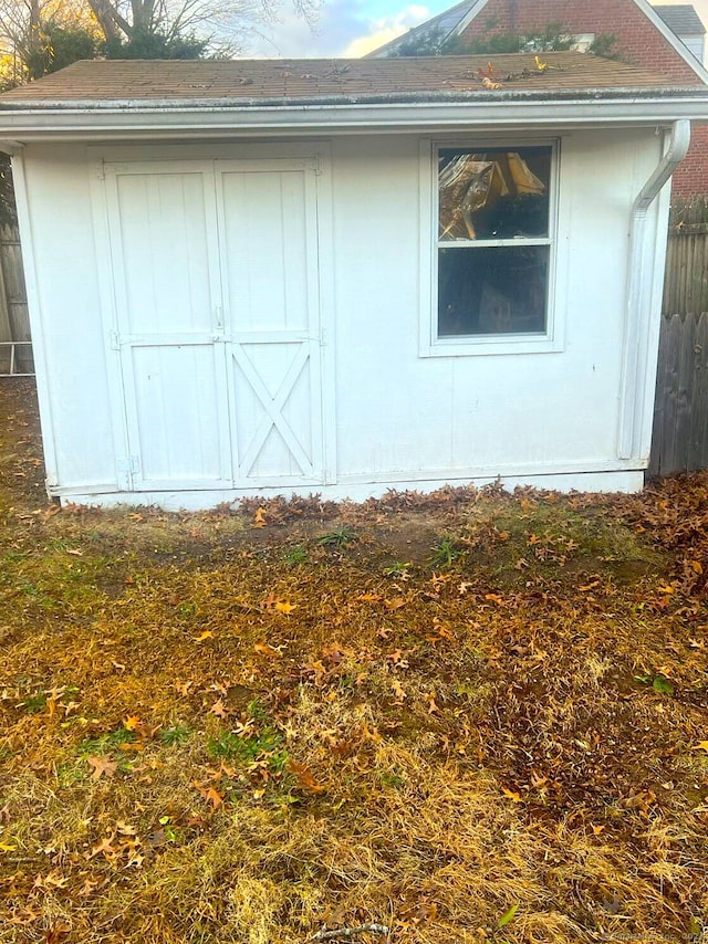 view of side of home with a storage shed